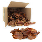 Box of dried dog treats with some outside the box on a white background